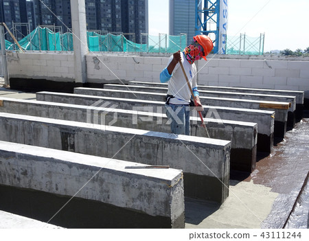 Waterproofing layer applied by construction worker Waterproofing layer applied by construction worker 43111244