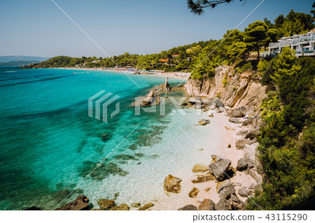 Bizarre rugged white rock cliffs near famous beach of Platys and Makrys gialos with pure clear Bizarre rugged white rock cliffs near famous beach of Platys and Makrys gialos with pure clear 43115290