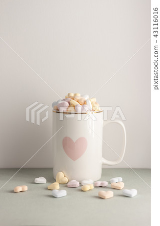 one white cup full of candy hearts 43116016