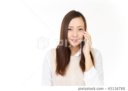 A woman talking on a smartphone A woman talking on a smartphone 43116788