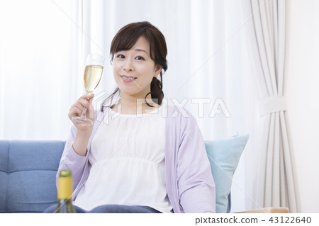 A woman relaxing wine and drinking it A woman relaxing wine and drinking it 43122640