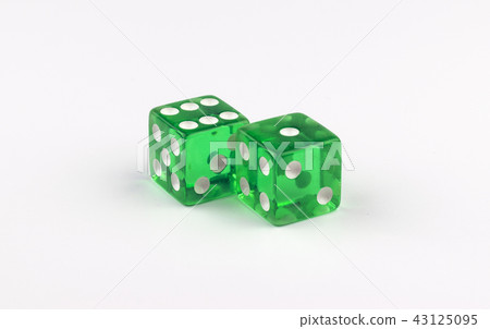 Green, translucent gaming dice showing seven spots Green, translucent gaming dice showing seven spots 43125095