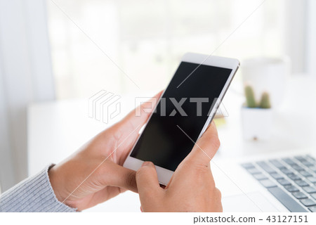 Woman hand holding white mobile phone 43127151