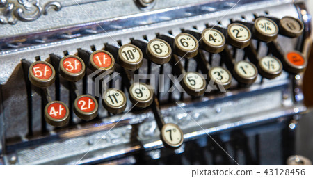 detail of old historic cash register with numbers 43128456