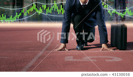 A businessman on a track ready for race in business A businessman on a track ready for race in business 43130038