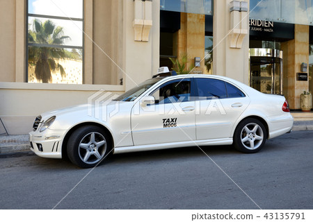 The Taxi car is near luxurious hotel, Malta The Taxi car is near luxurious hotel, Malta 43135791