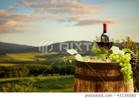Red wine bottle and wine glass on wodden barrel. Red wine bottle and wine glass on wodden barrel. 43136880