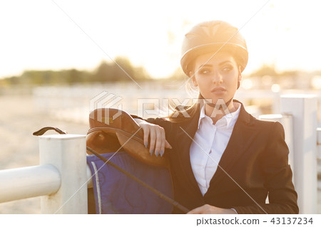 elegant rider woman in helmet with whip 43137234