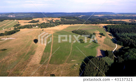 shadow of hot air balloon on the field 43137321
