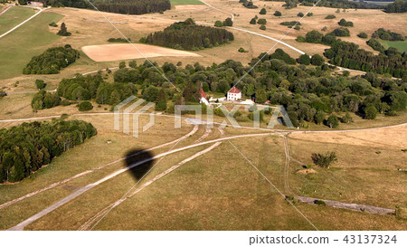 shadow of hot air balloon on the field 43137324