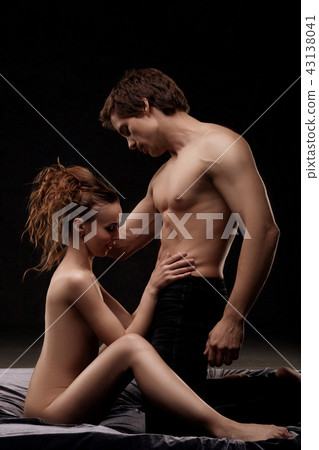 Loving attractive couple in bed in the dark Loving attractive couple in bed in the dark 43138041
