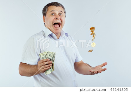 Joyful man tosses a coin Bitcoins. 43141805