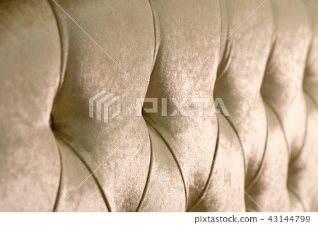 Beige soft textile background with symmetrical buttons on the corners of diamonds. Soft and Beige soft textile background with symmetrical buttons on the corners of diamonds. Soft and 43144799