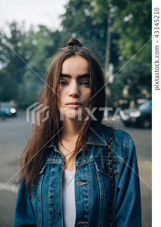 Portrait of beautiful young woman in city 43145210