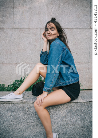 Portrait of fashionable girl sitting Portrait of fashionable girl sitting 43145212