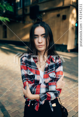 Teen girl with long dark hair looks at camera 43145231