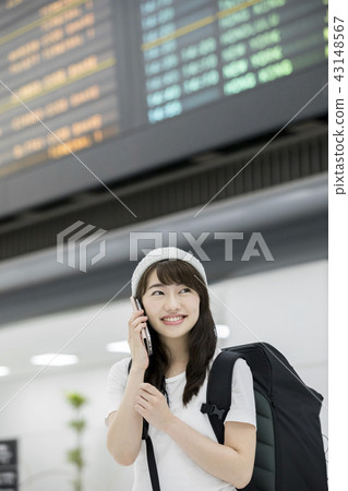 A backpacker woman making a call in the airport 43148567