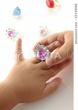 Child's hand playing with toy ring 43149466