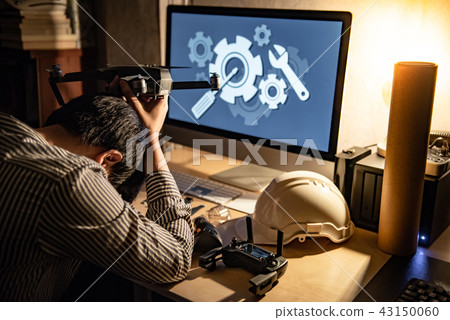 Technicia feeling stressed while repairing drone 43150060