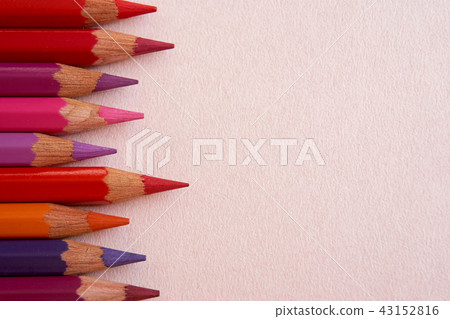 Red, orange, purple, and violet colored pencils with pointed spikes on a pink background. Red, orange, purple, and violet colored pencils with pointed spikes on a pink background. 43152816