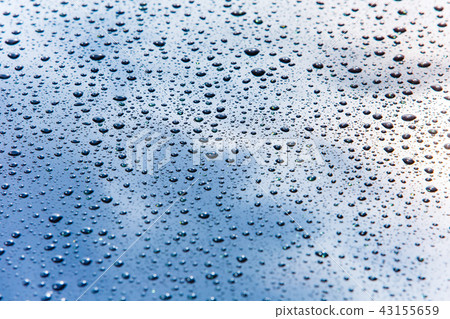Car hood covered in small water drops macro 43155659