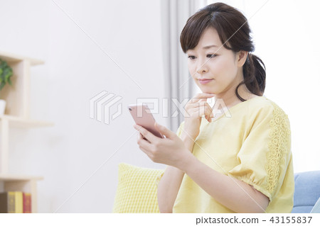 A woman operating a smartphone 43155837