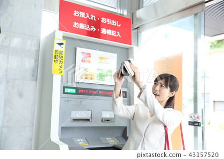 A woman using ATM A woman using ATM 43157520