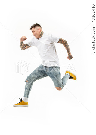 Freedom in moving. handsome young man jumping against white background 43162410