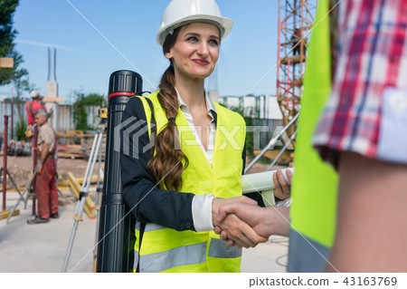 Architect and engineer or supervisor shaking hands on the construction site Architect and engineer or supervisor shaking hands on the construction site 43163769