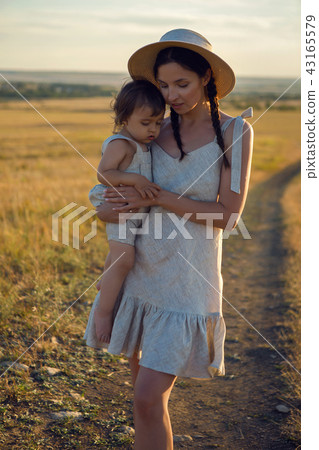 mother and son goes to the field at sunset mother and son goes to the field at sunset 43165579