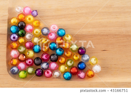 Beads, colorful beads on Wooden Tray background. Beads, colorful beads on Wooden Tray background. 43166751