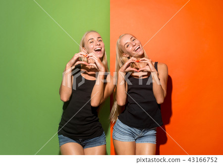 Portrait of attractive cute girls with bright makeup with kiss Portrait of attractive cute girls with bright makeup with kiss 43166752