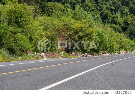 The pile of garbage on the side of road in Phuket. 43167093