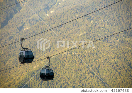 Close-up photo of two funiculars among mountain hills Close-up photo of two funiculars among mountain hills 43167488