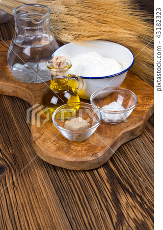 Fresh ingredients for pizza dough on wooden board Fresh ingredients for pizza dough on wooden board 43182323