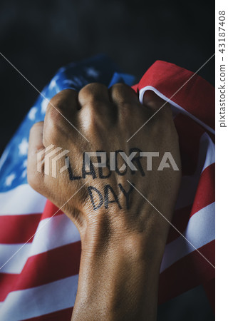 raised fist, american flag and text labor day 43187408