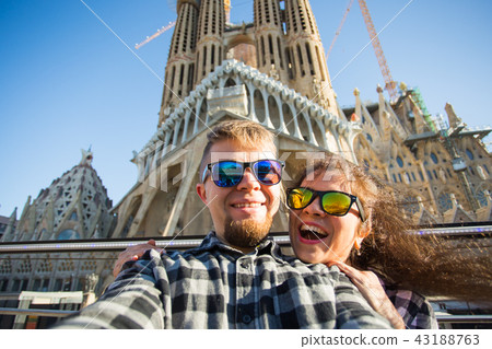 Travel, holidays and people concept - Happy couple taking selfie photo in front of the Sagrada Travel, holidays and people concept - Happy couple taking selfie photo in front of the Sagrada 43188763