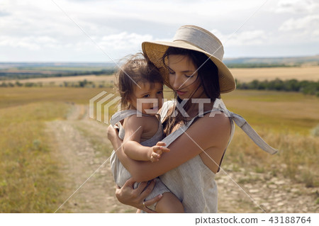 mother and son standing in the field at sunset mother and son standing in the field at sunset 43188764