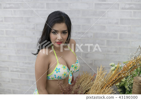 Woman in sexy  swimsuit poses in bedroom. 43190300