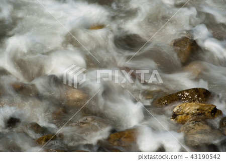 Soft waves on a rocky beach in the morning Soft waves on a rocky beach in the morning 43190542