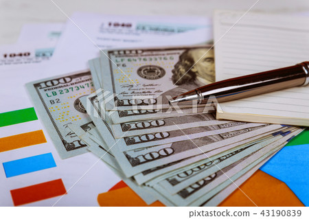 The tax 1040 forms with the money and the pen. The tax 1040 forms with the money and the pen. 43190839