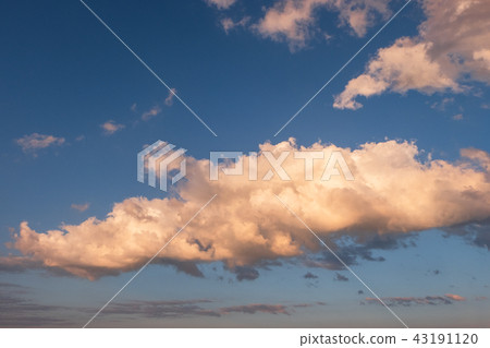 White clouds in summer blue sky at golden hour White clouds in summer blue sky at golden hour 43191120