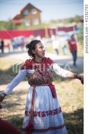 Beautiful woman in Russian national costume dances and sings Beautiful woman in Russian national costume dances and sings 43192783