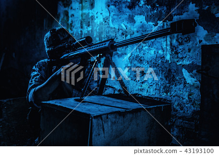 Army sniper firing with 50 caliber rifle at night 43193100