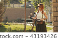Woman walking beside riding bicycle on city park. Woman bike park 43193426