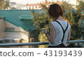 Young redhaired woman riding bicycle in city. Woman with mobile phone 43193439