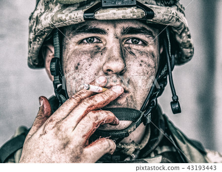 Stressed soldier with hands in blood smoking Stressed soldier with hands in blood smoking 43193443