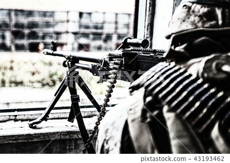 Commando machine gunner soldier firing from window Commando machine gunner soldier firing from window 43193462