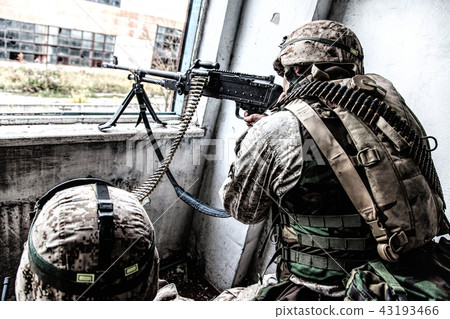 Army machine gunner attacks enemy with aimed fire Army machine gunner attacks enemy with aimed fire 43193466