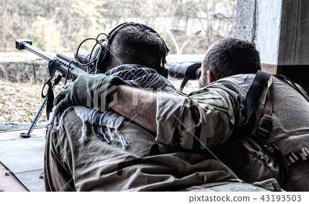 Army sniper team shooting from hidden position 43193503